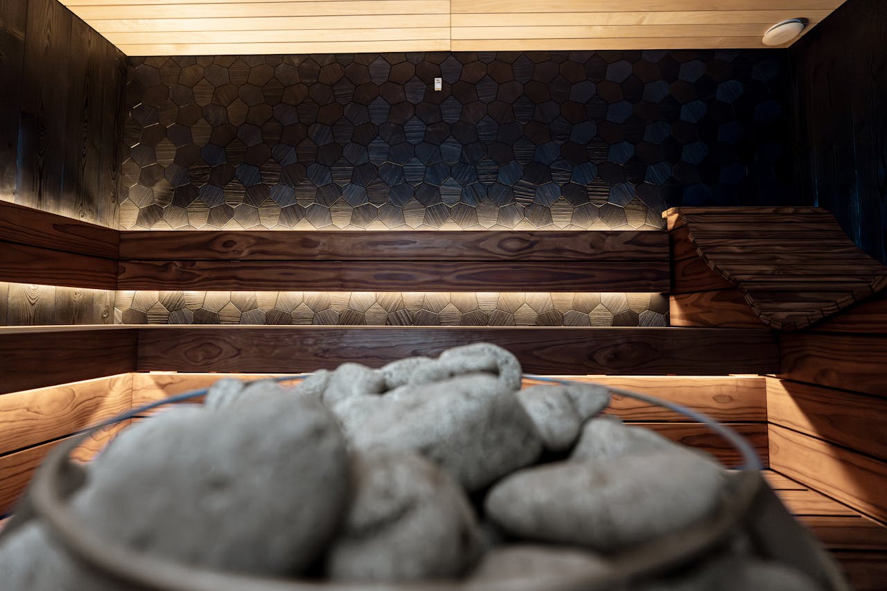Stylish indoor sauna featuring textured wall panels and warm wood lighting. Perfect for relaxation.